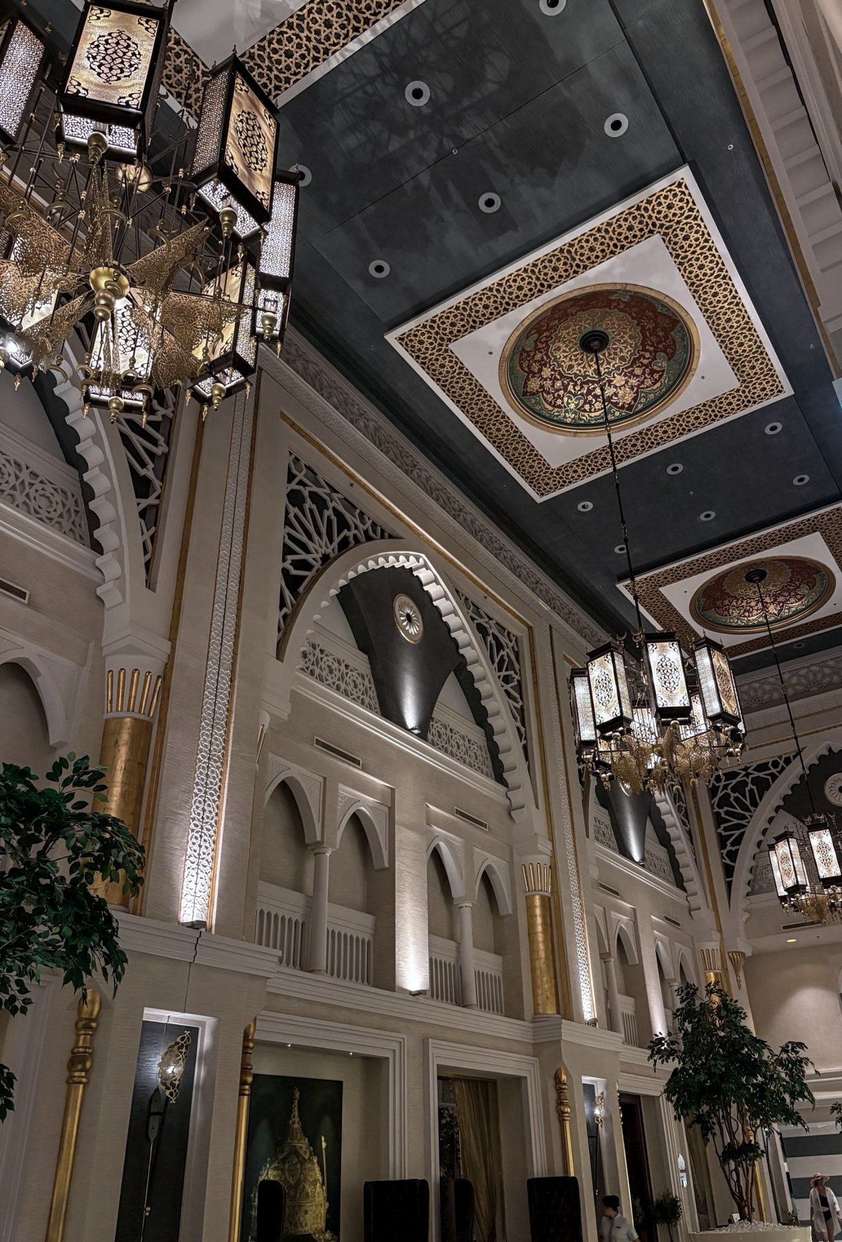 An ornate hotel lobby with chandeliers