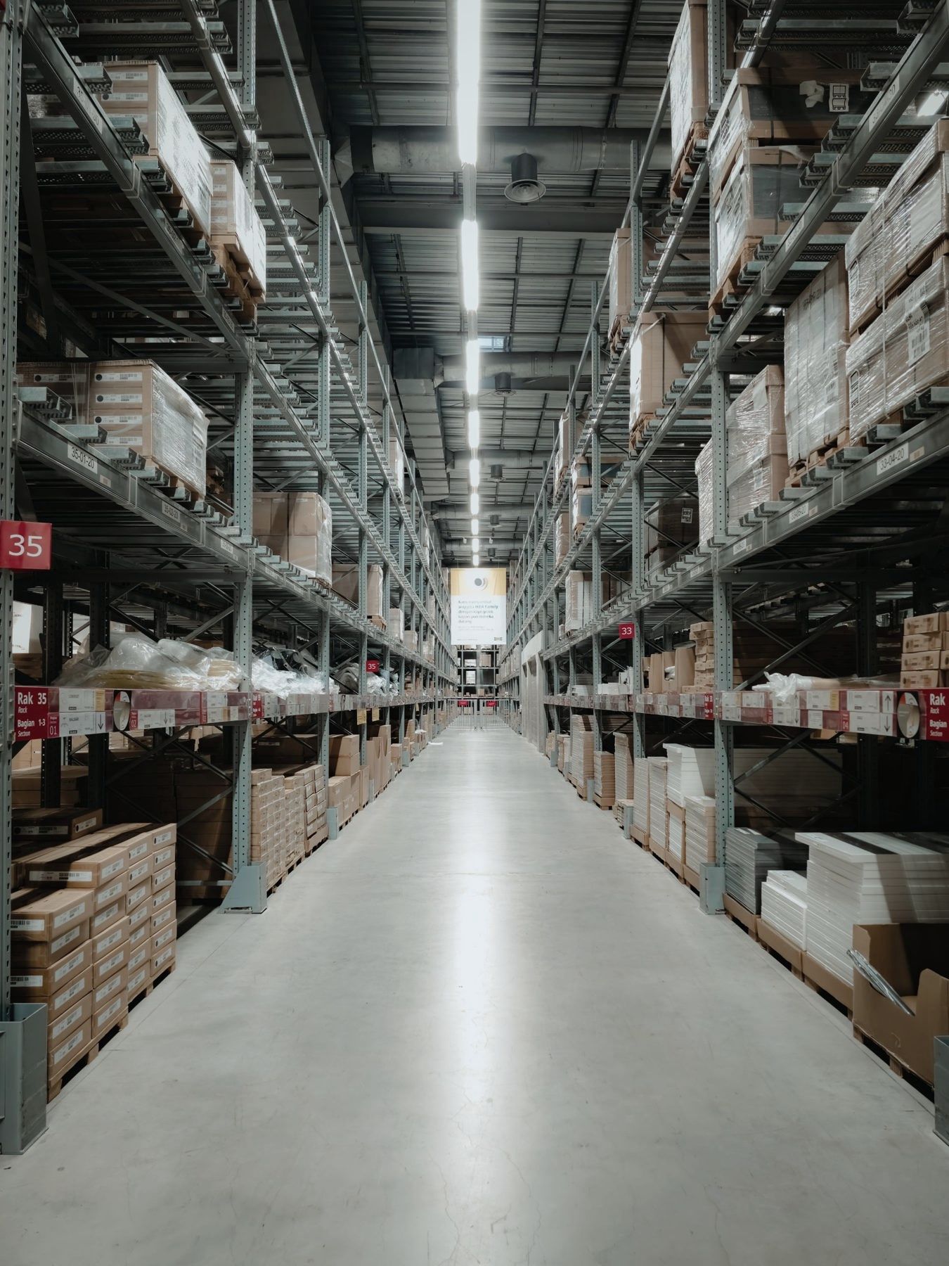 A long warehouse aisle with tall shelving